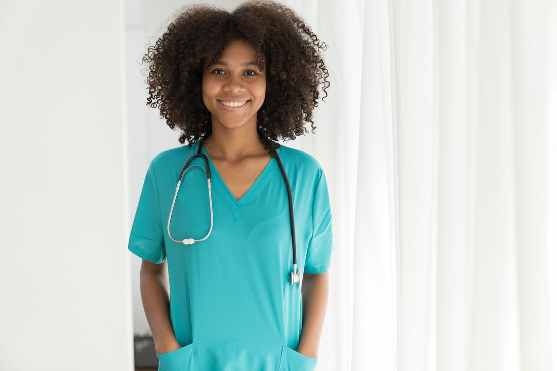 Healthcare worker in blue scrubs standing in a hospital